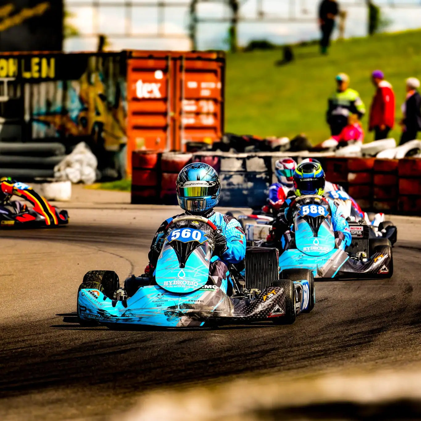 Blaues und schwarzes Go-Kart mit der Nummer 560 auf der Rückseite, mit glänzender Oberfläche und Sponsoraufklebern.